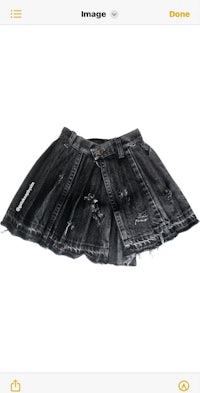 a black denim skirt with holes on it